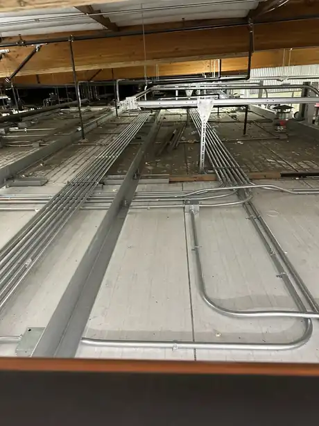 Rigid conduit risers feeding 480V three-phase disconnects at a ripening room