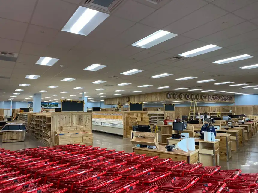 Grocery sales floor before opening, recessed troffer lighting on and checkout stands set